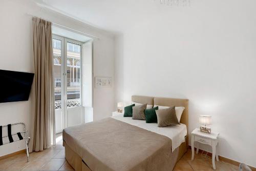 a bedroom with a large bed with a window at Sorrentina Guest House in Sorrento