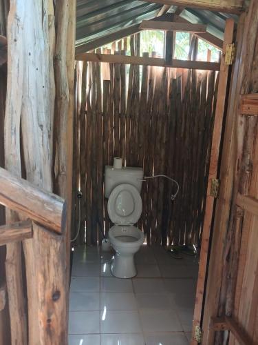 a bathroom with a toilet in a wooden structure at Gabsgate Resort Kilifi in Kilifi
