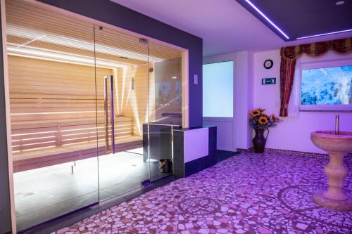 a bathroom with a glass shower and a sink at Hotel Orchidea in Passo del Tonale