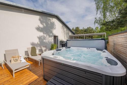 a large hot tub on a deck with a patio at BALI BLIZZ - App 12 in Benz