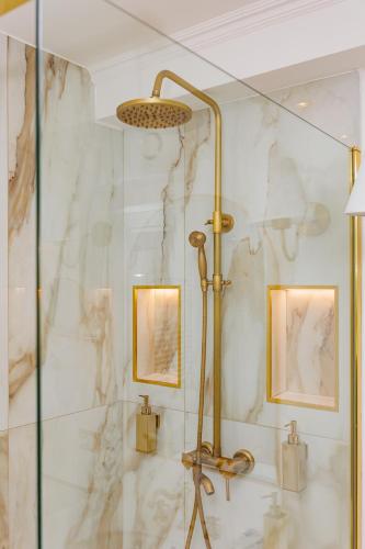 a shower in a bathroom with a marble wall at Maison 31 - Unique Experience in Civitavecchia