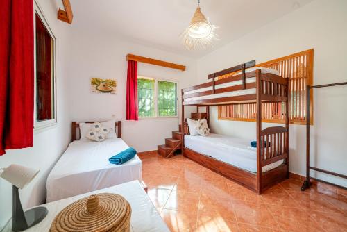 two beds in a room with a bunk bed at Paradise Farm 20 min from Rabat By MasterHost with AC in Salé