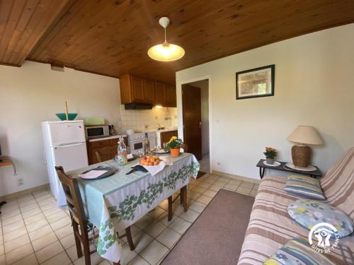 a kitchen and dining room with a table and a couch at Mas garrigole in Eus
