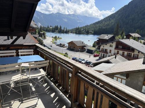 a balcony with a view of a town and a lake at L'Attique du Vieux-Champex in Orsières