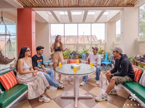 a group of people sitting around a table at Zostel Jaipur in Jaipur
