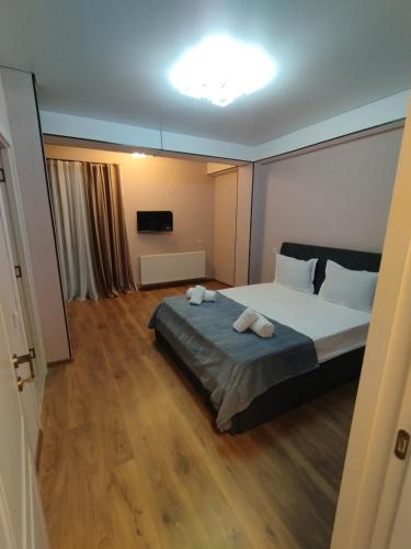 a bedroom with a bed with two towels on it at Hotel G&G in Tsaghveri