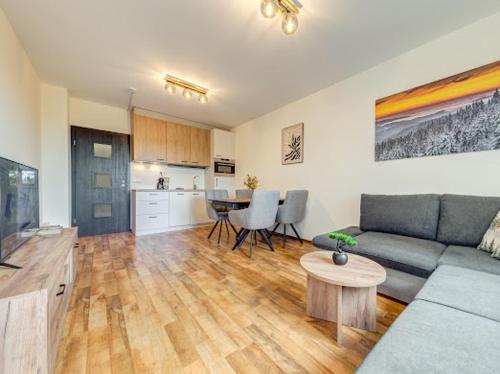 a living room with a couch and a table at Apartment Kapina in Pamporovo
