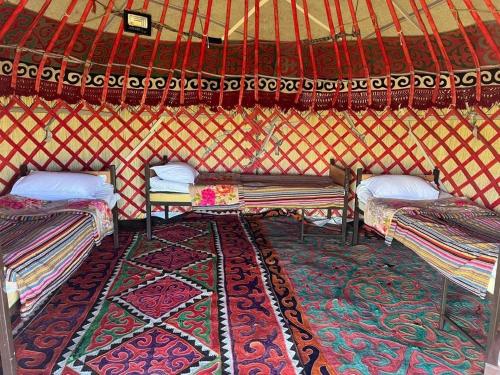 a room with three beds in a yurt at Kambar-ata yurt camp in Song-Kul