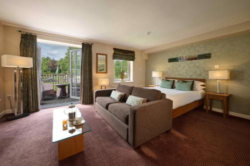 a hotel room with a bed and a couch at Landal Whitbarrow in Penruddock