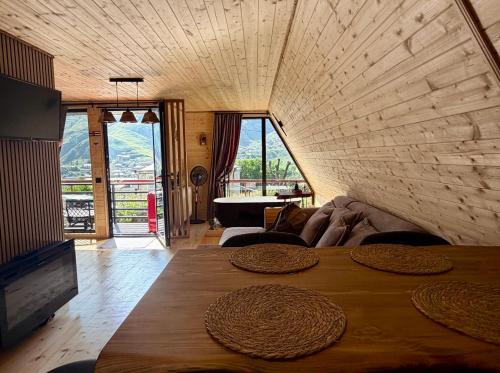 a living room with a table and a couch at Golden Star Cottage in Kazbegi