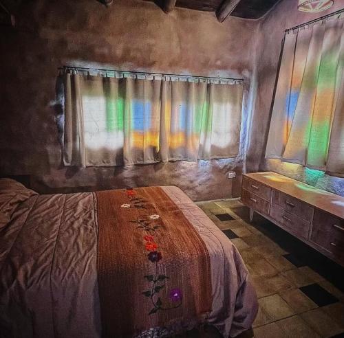 a bedroom with a bed and a window with rainbow colors at Kamiare in San Esteban