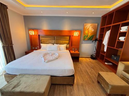 a bedroom with a large bed with a white bedspread at 2RN SOLOMON Hotel and Spa 