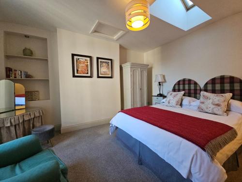 a bedroom with a large bed and a couch at Eden's House in Hexham