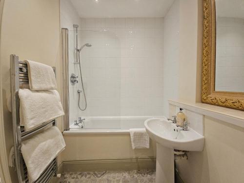a bathroom with a sink and a shower and a tub at Eden's House in Hexham