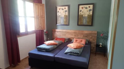 a blue couch with pillows on it in a room at Casa Las Maletas in Morote