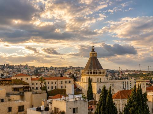 a view of theatican city at sunset at El Khan Guesthouse & Art - A Complex of 4 Middle Eastern-Style Suites in Nazareth
