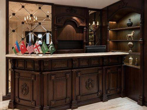 a kitchen with a wooden island with flags on it at Midway Park Hotel in Baku