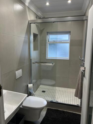 a bathroom with a shower and a toilet at Arbeidsgenot, Unit 2 in Herolds Bay