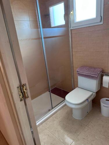 a bathroom with a toilet and a shower at Chalet Calan Bosch in Cala en Bosc