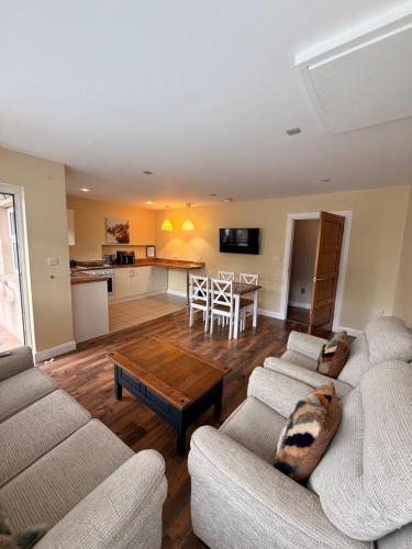 a living room with two couches and a table at Causeway Lodge in Bushmills