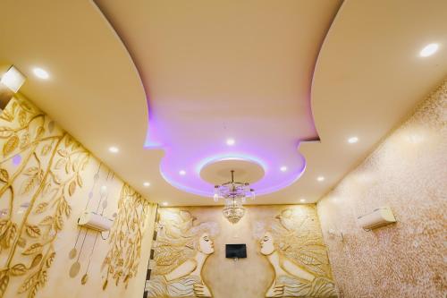 a room with a ceiling with a painting on the walls at K2 Highway Treat & Resort Unit of Lyzon in Bhadaura