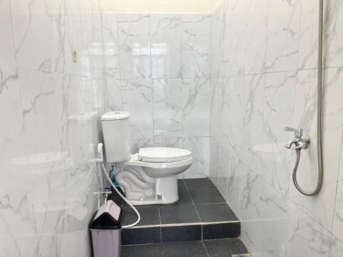 a white bathroom with a toilet and a shower at Villa Kay Terrace in Campaka