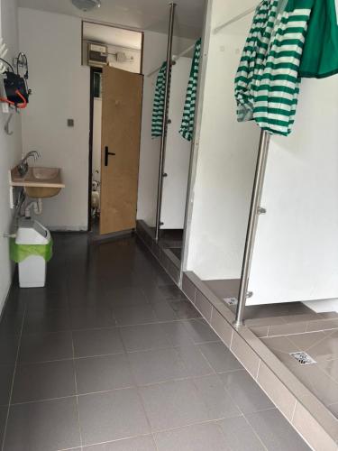 a bathroom with a shower and a sink and a mirror at Pole namiotowe u Józia in Borne Sulinowo