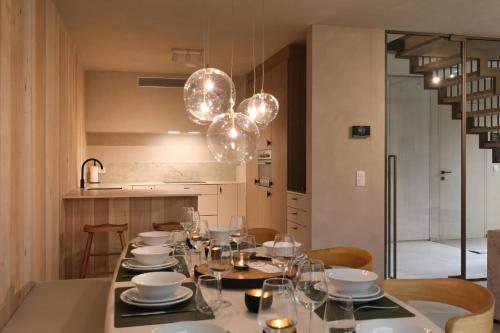 a dining room with a table with plates and glasses at Luxury Lodge with Jacuzzi for 8 – Woodz Lodges in Heusden - Zolder
