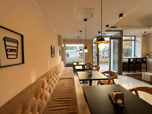 a large couch in a room with tables and chairs at Hotel Attaché in Vienna
