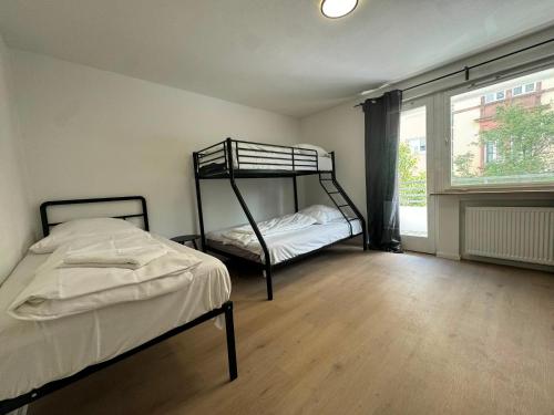 a bedroom with two bunk beds and a window at Tulpen Residenz in Offenbach