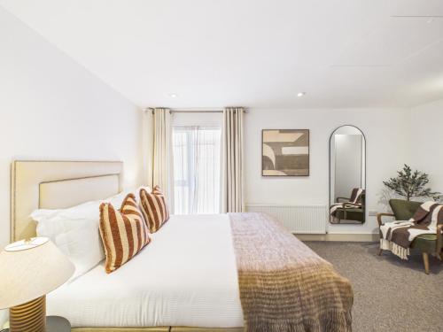 a bedroom with a large bed and a living room at Westminster Residences by Apt in London