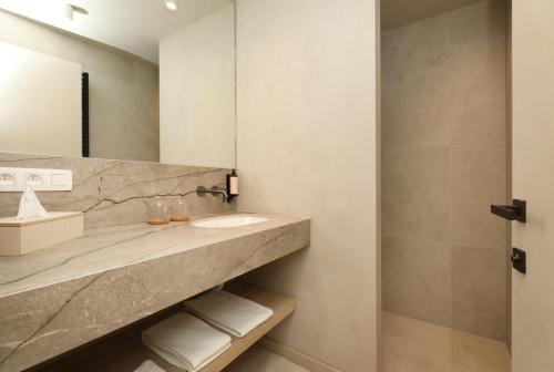 a bathroom with a sink and a mirror at Lodge with Jacuzzi | 6 persons in Heusden - Zolder