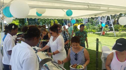 a group of people standing under a tent at Rapopo Plantation Resort in Kokopo