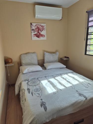a bedroom with a large bed in a room at Le Ghirol - Tiny Houses & Nature in Quesnel