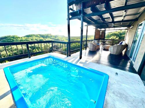 a swimming pool on the deck of a house at Athule Inn - Mozambique in Chidenguele