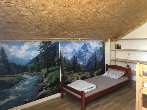 a bedroom with a mural of a river and mountains at Smještaj Klekovača in Drvar
