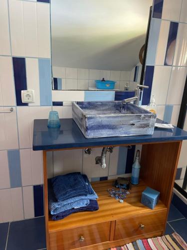 a bathroom with a sink and a mirror at Yellow Attic in Senhora do Rosário