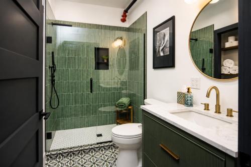a bathroom with a shower and a toilet and a sink at Best Intentions in Port Clinton