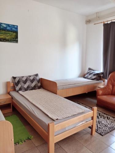 a living room with two beds and a couch at Smeštaj Mevlida in Belo Blato