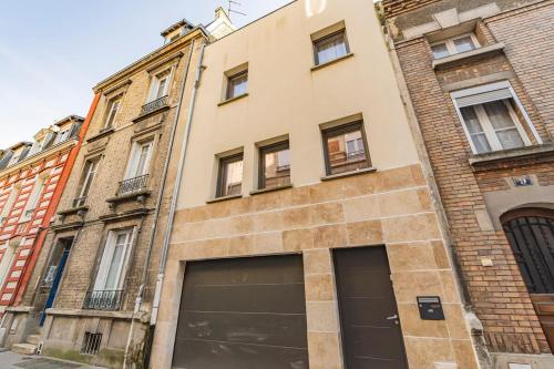 a building with two garage doors in front of it at MM Suites Town House Terrasse in Reims