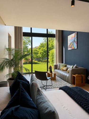 a living room with a couch and a large window at 4 Lulworth in Johannesburg