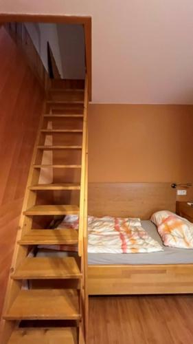 a bunk bed with a staircase in a room at Penzion Padrtův mlýn in Třebíč