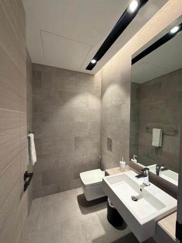 a bathroom with a sink and a toilet and a mirror at Fontana infinity in Manama