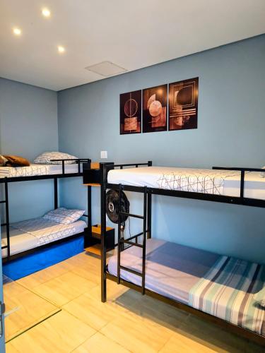 a room with three bunk beds in it at Refúgio Alemar in Ribeirão Preto