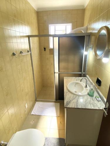 a small bathroom with a toilet and a sink at RCM Vilas - Casa Confortável 02 in Joinville