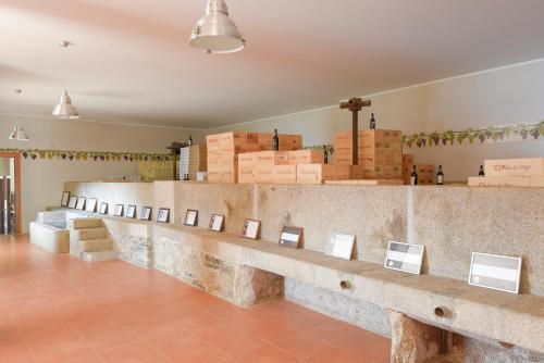 a room with a counter with pictures on it at Hotel Rural Quinta Do Pego in Tabuaço