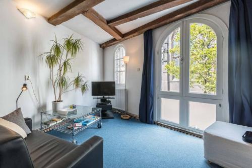 a living room with a couch and a window at Anny's Warehouse City Centre! in Amsterdam