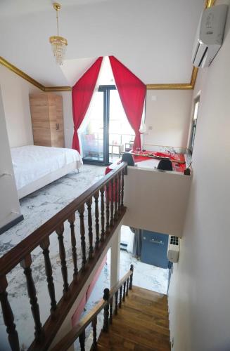a room with a bed and a staircase with a bed and a window at EYLA VİLLA in Trabzon