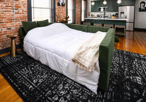a large bed in a living room next to a kitchen at Best Intentions in Port Clinton