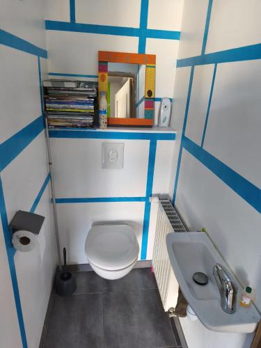 a small bathroom with a toilet and a sink at Maison Relax in Flers
